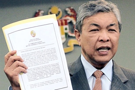 Document in hand: Dr Ahmad Zahid showing the press statement on the status of BOC holders during the press conference in Putrajaya.